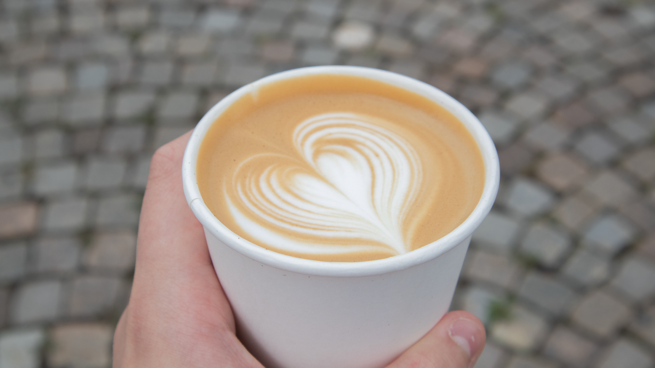 En kopp kaffe med skum som har mönster som ett hjärta En kopp kaffe med skum som har mönster som ett hjärta